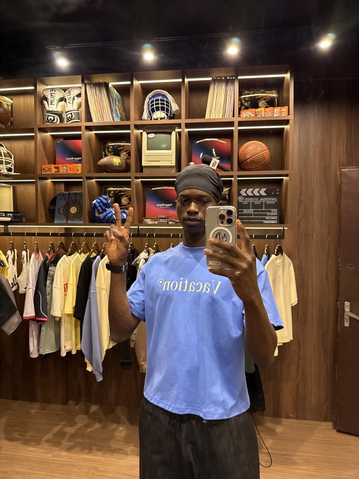 Mirror selfie in a light-blue tee
